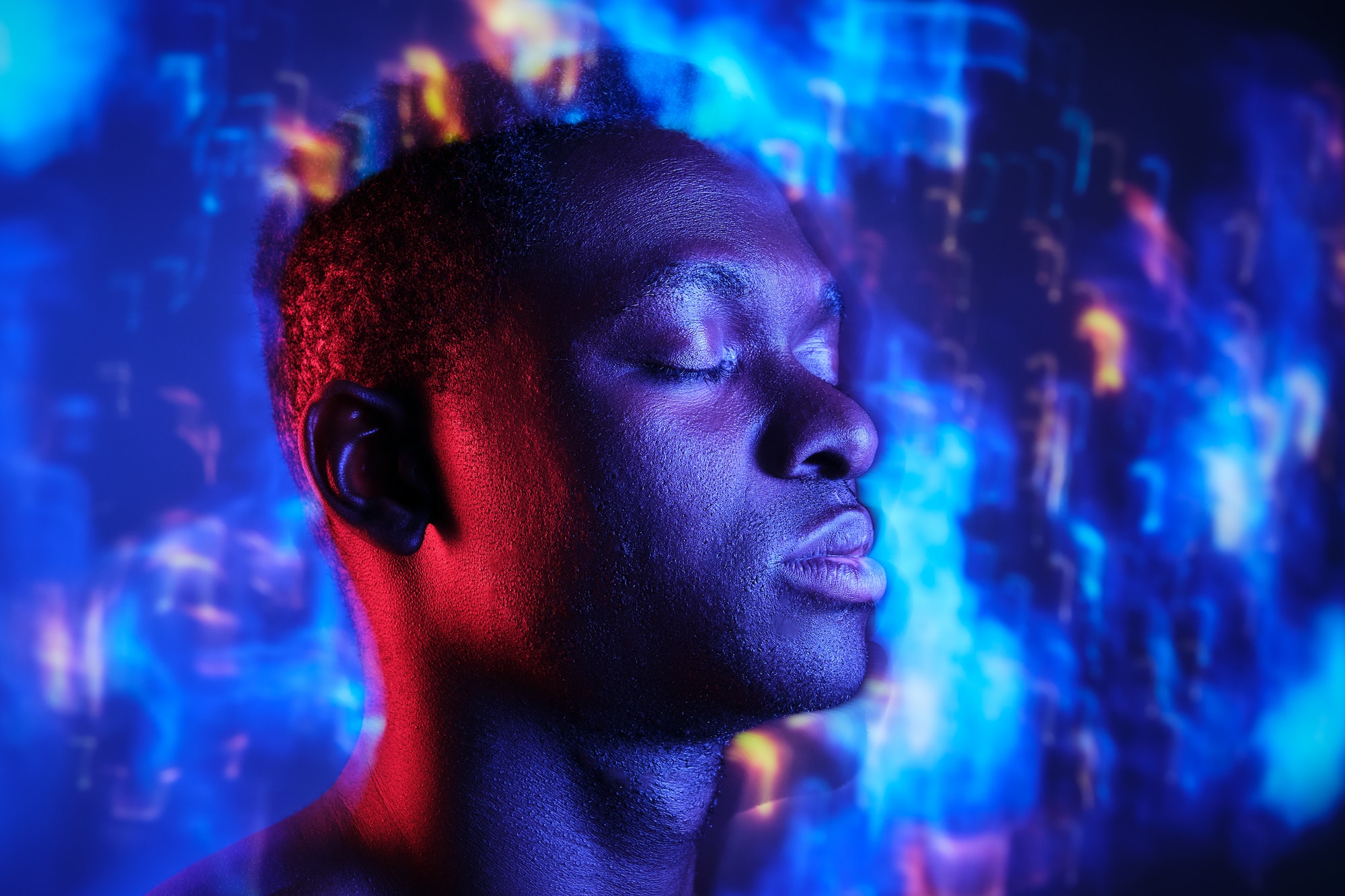 Serene black man against neon lights